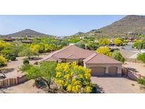 Stunning single-story home with a three-car garage surrounded by lush landscaping and mature trees at 2924 W Here To There Dr, Phoenix, AZ 85086