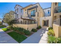 Modern two-story home featuring a private patio, small lawn and covered parking area at 300 N Gila Springs Blvd # 164, Chandler, AZ 85226