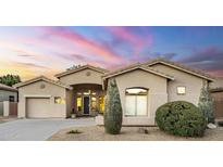 Charming single-story home with a neutral color palette, desert landscaping and inviting front entrance and attached garage at 330 W Locust Dr, Chandler, AZ 85248