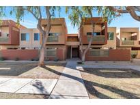 Contemporary apartment building with neutral colors, balconies, and well-maintained landscaping creates an inviting curb appeal at 3500 N Hayden Rd # 2109, Scottsdale, AZ 85251