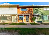 Charming townhomes with colorful exteriors and well-maintained lawns in a vibrant community setting at 4341 W Ocotillo Rd, Glendale, AZ 85301