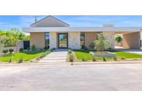 Stunning front exterior with stone accents, lush landscaping, and a modern walkway leading to the entrance at 4704 N 40Th Pl, Phoenix, AZ 85018