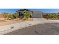 Charming single-story home with a well-manicured front yard and a two-car garage at 9313 S 39Th Dr, Laveen, AZ 85339