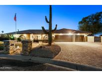 Inviting single-story home with well-manicured landscaping and a paver driveway at 1235 E Clearview Dr, Casa Grande, AZ 85122