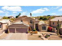 Inviting two-story home features a well-manicured front yard and a two-car garage, creating a warm curb appeal at 1302 E Voltaire Ave, Phoenix, AZ 85022