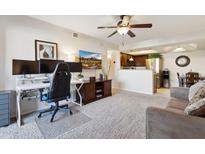 Cozy living room with a home office, comfortable seating, and modern ceiling fan at 1720 E Thunderbird Rd # 2090, Phoenix, AZ 85022