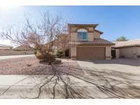 Charming two-story home with desert landscaping and a two-car garage under a sunny blue sky at 1883 E Tremaine Ave, Gilbert, AZ 85234
