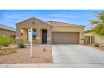 Charming single-story home featuring a well-maintained yard and attached two-car garage at 2296 S 235Th Dr, Buckeye, AZ 85326
