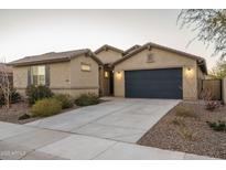Charming single-story home featuring a two-car garage, desert landscaping, and a neutral color palette at 25330 N 134Th Dr, Peoria, AZ 85383