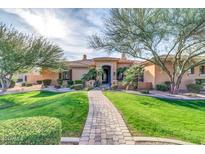 Charming one-story home featuring a tile roof, manicured lawn, and a decorative stone walkway at 2799 E Jade Pl, Chandler, AZ 85286