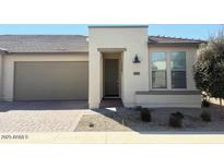 Inviting single-story home with a charming exterior and well-maintained landscaping and a two car garage at 357 E Las Puertas Ln, Queen Creek, AZ 85140