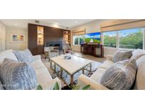 Bright living room featuring a fireplace, built-in shelving, and comfortable seating at 6166 N Scottsdale Rd # B1005, Paradise Valley, AZ 85253