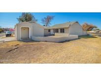 Charming single-story home featuring a low block wall, open carport, and desert landscaping for a welcoming aesthetic at 7018 S 41St Pl, Phoenix, AZ 85042