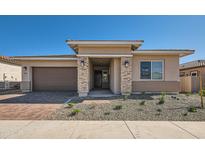 Charming single-story home featuring stone accents, a two-car garage, and well-maintained landscaping at 855 W Peralta Pass, Apache Junction, AZ 85120