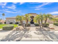 Inviting single-story home with palm trees and a neutral-toned exterior, set against a beautiful blue sky at 9167 E Tarantini Ln, Scottsdale, AZ 85260