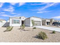 Charming single-story home with desert landscaping, a two-car garage, and a welcoming entrance at 10320 E Lupine Ln, Florence, AZ 85132