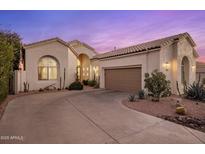 Charming stucco home featuring a two-car garage and desert landscaping for a clean, modern look at 11627 E Bella Vista Dr, Scottsdale, AZ 85259