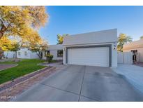 Charming home featuring a well-manicured lawn and a two-car garage with a large driveway at 1601 E Elgin St, Chandler, AZ 85225