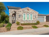 Charming stone house with manicured landscaping and a lovely arched entryway at 22426 N 29Th Pl, Phoenix, AZ 85050