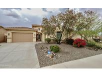 Inviting home featuring a tiled roof, mature desert landscaping, and a secure gated entry at 31483 N 133Rd Dr, Peoria, AZ 85383