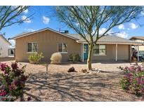 Charming single-story home with desert landscaping and a pop of color from the turquoise front door at 3342 N 63Rd Ave, Phoenix, AZ 85033