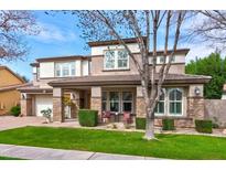 Beautiful two-story home with stone accents, manicured lawn, covered porch and a two car garage at 3744 E Sierra Madre Ave, Gilbert, AZ 85296