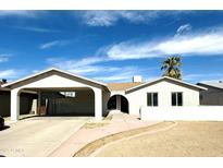 Charming single-story home with a neutral facade, covered parking and desert landscaping at 4038 E Burgess Ln, Phoenix, AZ 85042