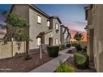 Charming townhome boasts a landscaped front yard and inviting entrance at twilight at 4669 E Olney Ave, Gilbert, AZ 85234