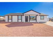 Charming single-story home featuring a fresh exterior, gravel landscaping and inviting front porch at 645 N 97Th St, Mesa, AZ 85207