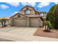 Charming two-story home with a tile roof, three-car garage, and mature landscaping at 827 W Kesler Ln, Chandler, AZ 85225