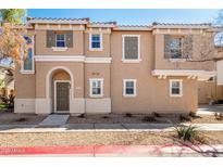 Charming two-story home featuring an arched entryway and desert landscaping at 923 W Wendy Way, Gilbert, AZ 85233