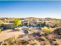 Stunning desert home featuring landscaped grounds, spacious driveway and neutral color palette at 9887 E Palo Brea Dr, Scottsdale, AZ 85262