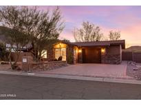 Charming home featuring desert landscaping, a brick driveway, and warm exterior lighting at 10611 N 9Th Dr, Phoenix, AZ 85029