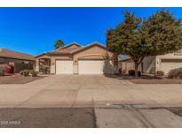 Charming single-story home featuring a well-maintained front yard and a convenient two-car garage at 12622 W Apodaca Dr, Litchfield Park, AZ 85340