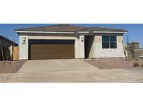 Charming single-story home with a two-car garage and a well-maintained front yard at 18334 W Desert Holw Dr, Wittmann, AZ 85361