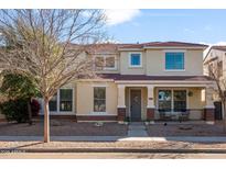 Charming two-story home with well-maintained landscaping, inviting porch, and neutral color scheme at 1893 S Sinova S Ave, Gilbert, AZ 85295