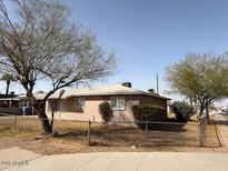 Modest single-story home with simple landscaping and a chain-link fence at 1950 E Wier Ave, Phoenix, AZ 85040