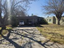 Charming single-story home featuring a covered carport and mature trees in a well-established neighborhood at 2423 E Flower St, Phoenix, AZ 85016