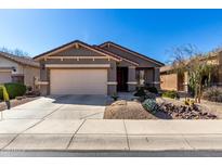 Charming single-story home with a two-car garage and desert landscaping in front of a well-maintained residence at 29986 N Jillian Dr, San Tan Valley, AZ 85143