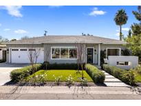 Charming single-story home with a well-manicured front yard and inviting entryway at 4119 E Indianola Ave, Phoenix, AZ 85018