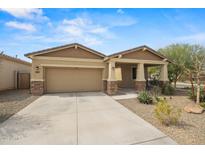 Charming single-story home featuring a covered front porch and low-maintenance desert landscaping at 4708 S 117Th Ave, Avondale, AZ 85323