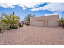 Expansive brick driveway leading to an attached two-car garage at 7211 E Rising Star Way, Carefree, AZ 85377