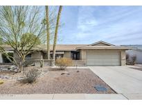 Charming single-story brick home featuring a well-kept front yard with desert landscaping and a two-car garage at 7629 N Via De La Campana --, Scottsdale, AZ 85258