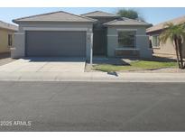 Charming single-story home with a well-manicured lawn and a two-car garage at 9121 W Alvarado St, Phoenix, AZ 85037