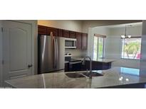 Bright kitchen featuring stainless appliances, granite countertops and a convenient breakfast bar at 9121 W Alvarado St, Phoenix, AZ 85037