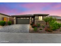 Charming single-story home with a well-manicured front yard and a two-car garage at 13224 W Crimson Ter, Peoria, AZ 85383