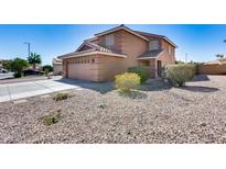 Charming two-story home featuring a two-car garage and low maintenance desert landscaping at 162 N 225Th Dr, Buckeye, AZ 85326