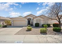 Inviting single-story home featuring a two-car garage and a well-maintained xeriscaped front yard at 16351 W Central St, Surprise, AZ 85388