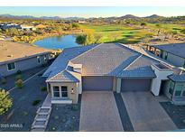 Stunning aerial view of home with desert landscaping, brick driveway, and golf course views at 17721 E Bismark Lake Ct, Rio Verde, AZ 85263