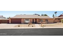 Charming single-story brick home with desert landscaping and a two-car garage at 2349 E Sahuaro Dr, Phoenix, AZ 85028